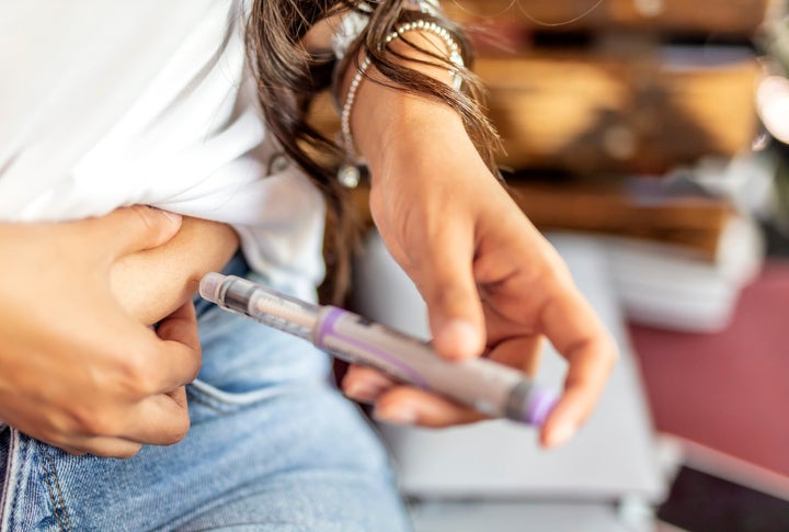 Woman injecting insulin