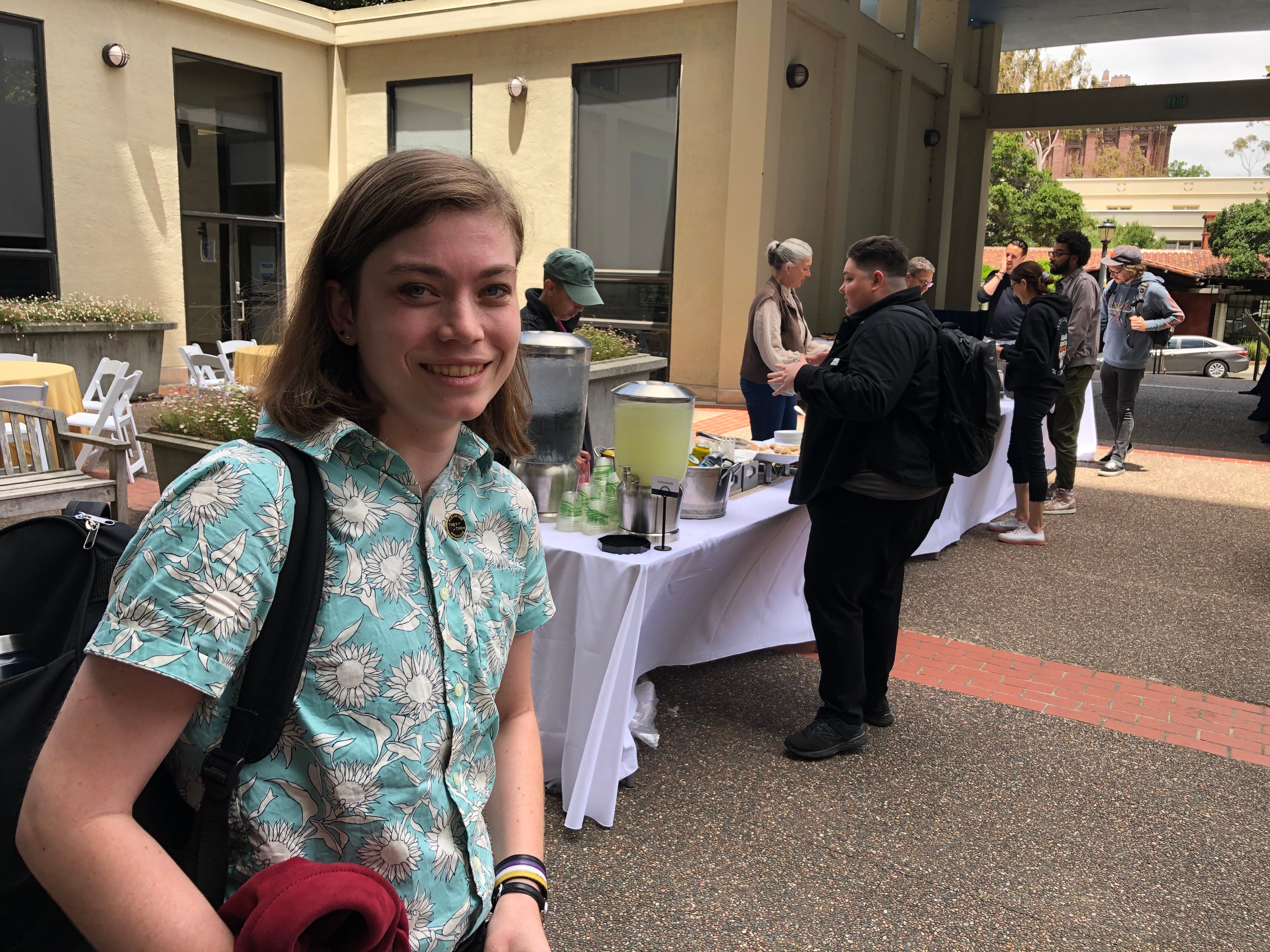 Young teacher, Bridgit Lee, smiles at a registration table in Berkeley