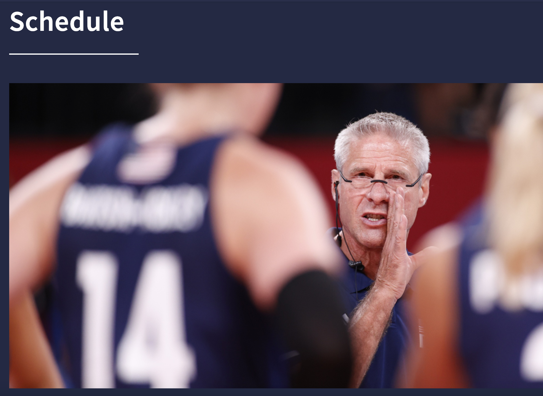 Screenshot of UCLA 2024 Paris Olympics website featuring the heading Schedule and white man with glasses, Karch Kiraly, saying something in confidence to a player on the court