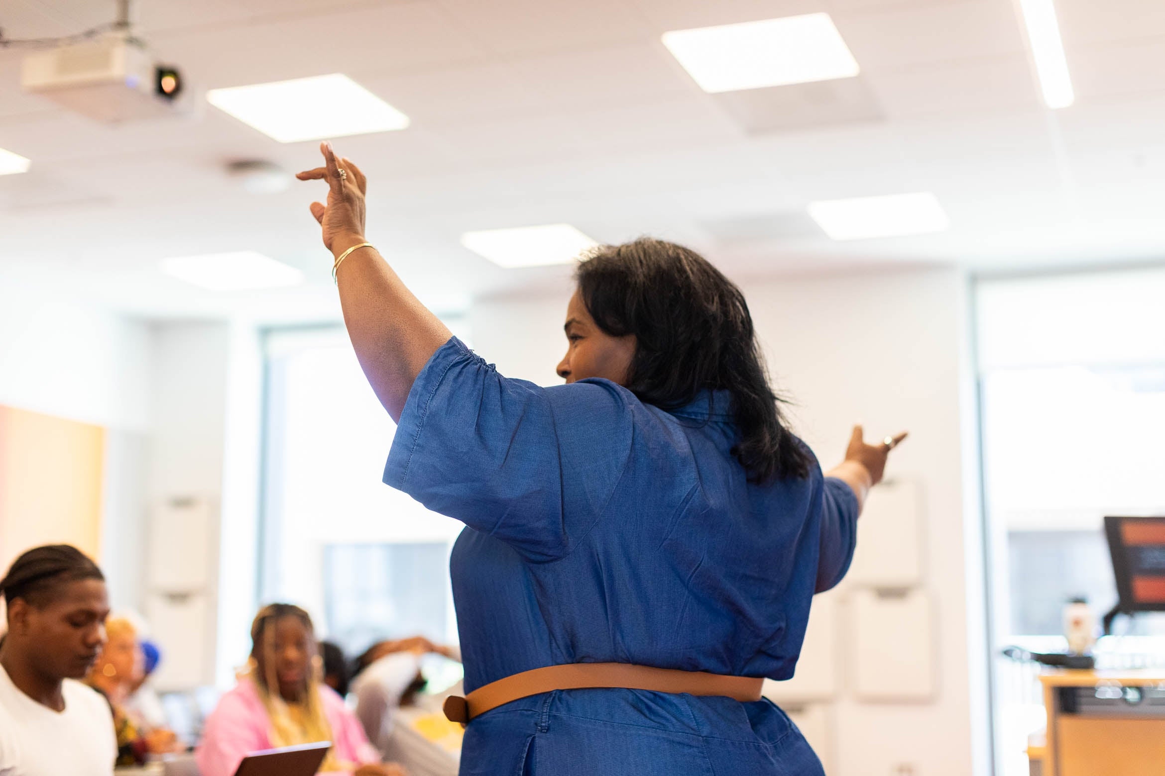 A teacher gesturing during a lecture