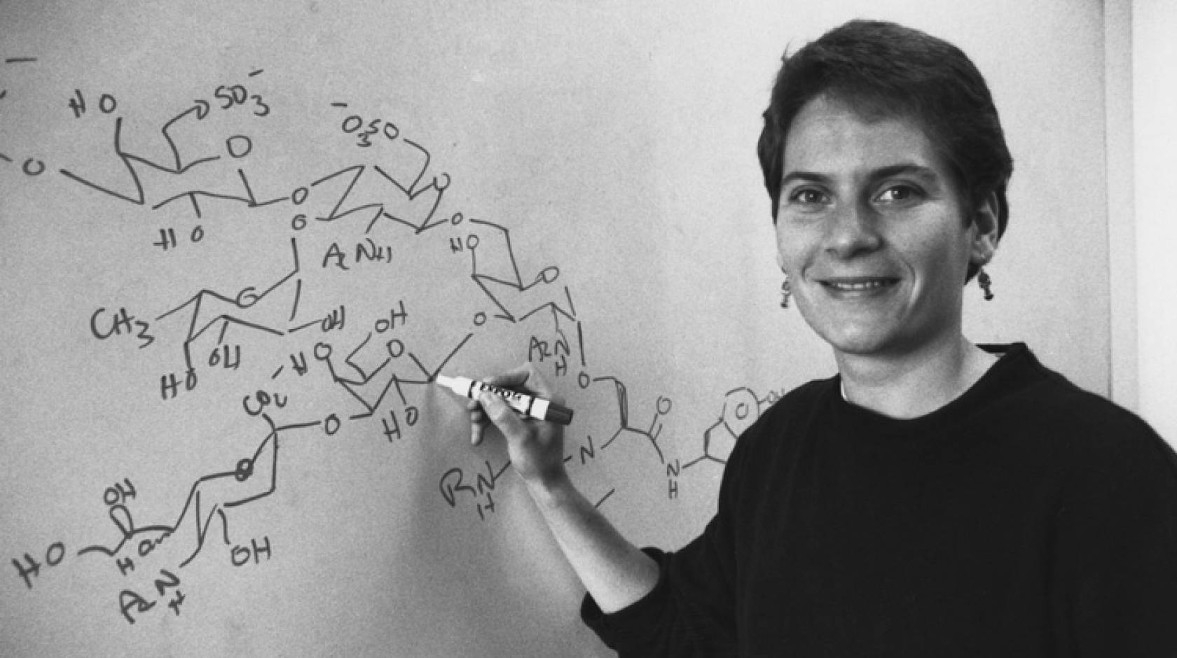 A woman writing on a whiteboard