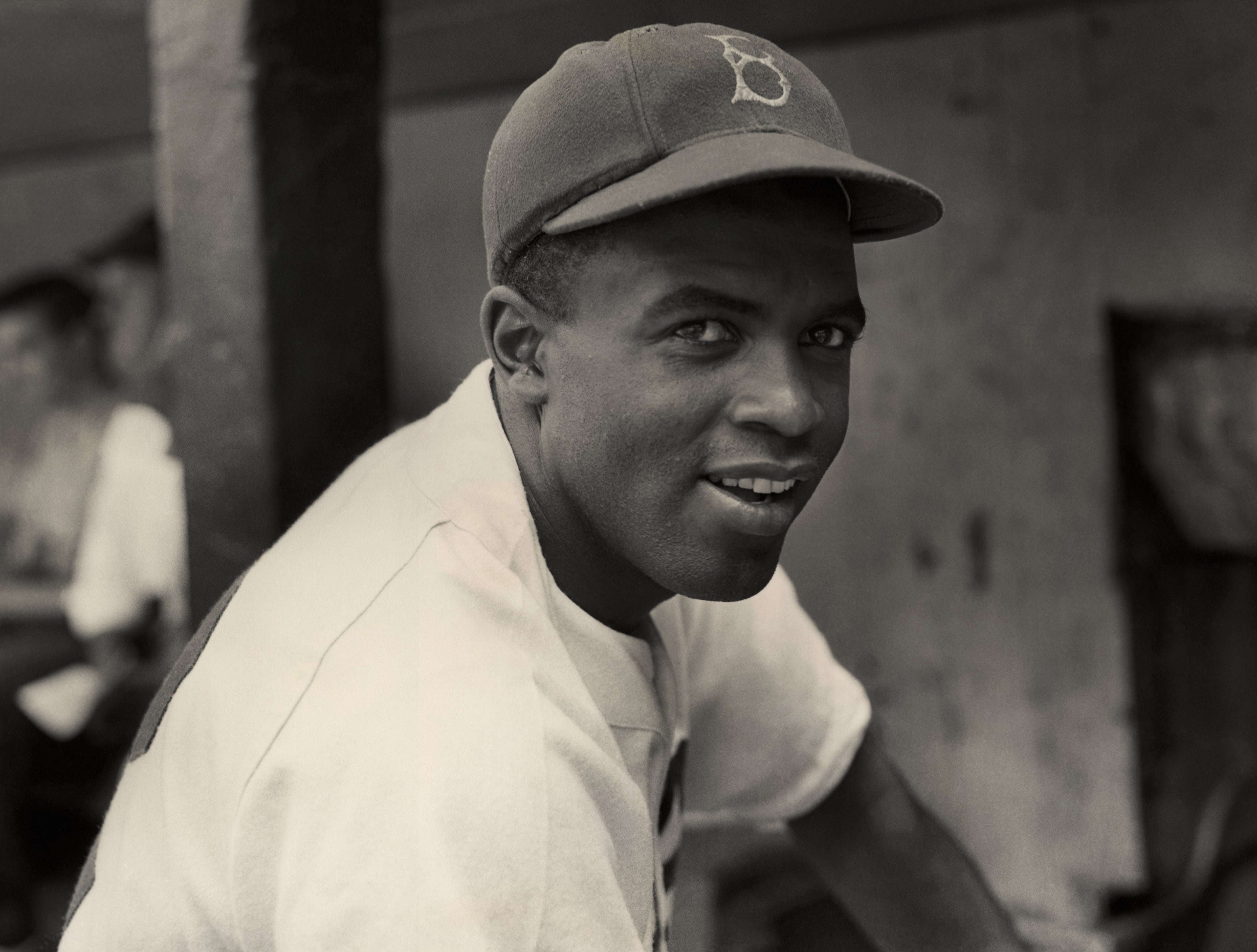Jackie Robinson smiles in his Brooklyn Dodgers uniform