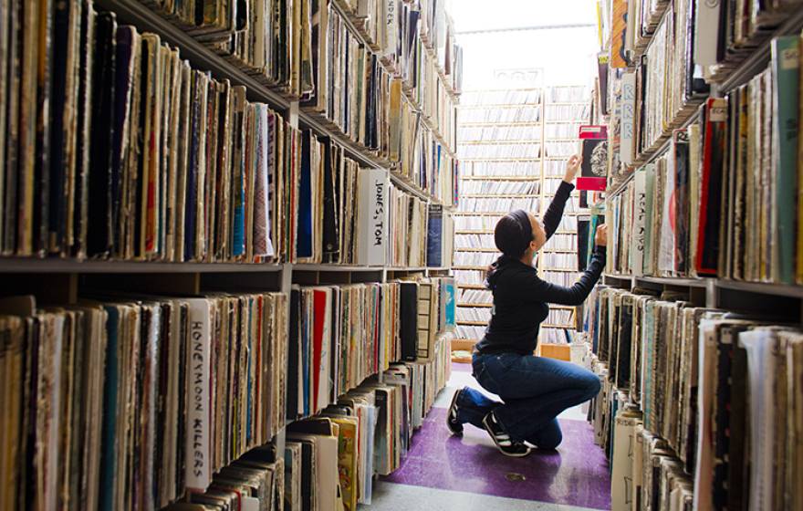Student looks through the music archive of KALX on the UC Berkeley campus